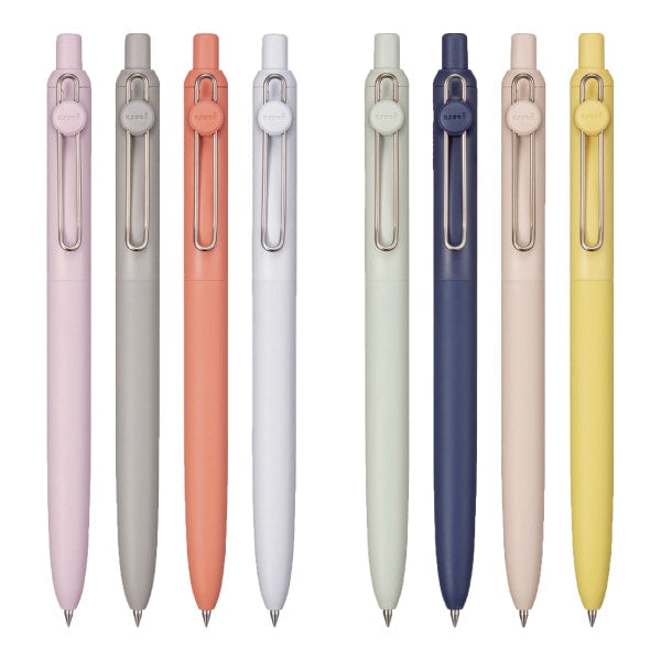 Set of eight pens in various pastel colors on a white background
