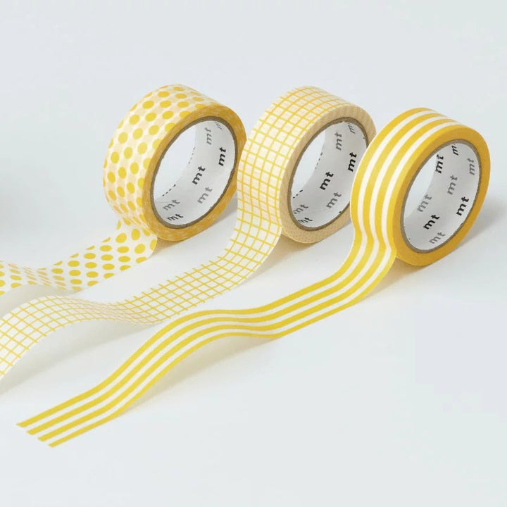 Yellow washi tape with different patterns on a white background