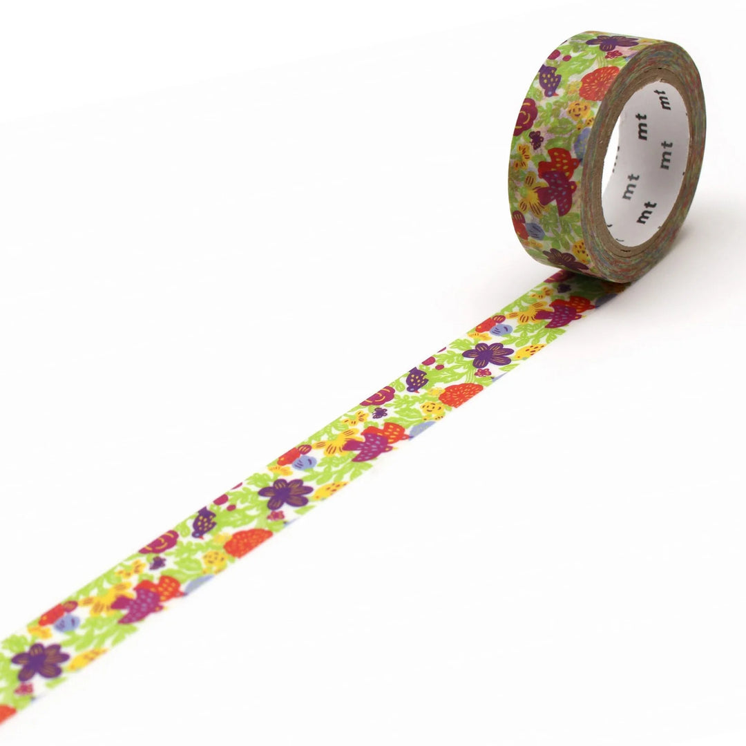A roll of washi tape with a floral pattern featuring various colors such as purple, green, and red on a white background.
