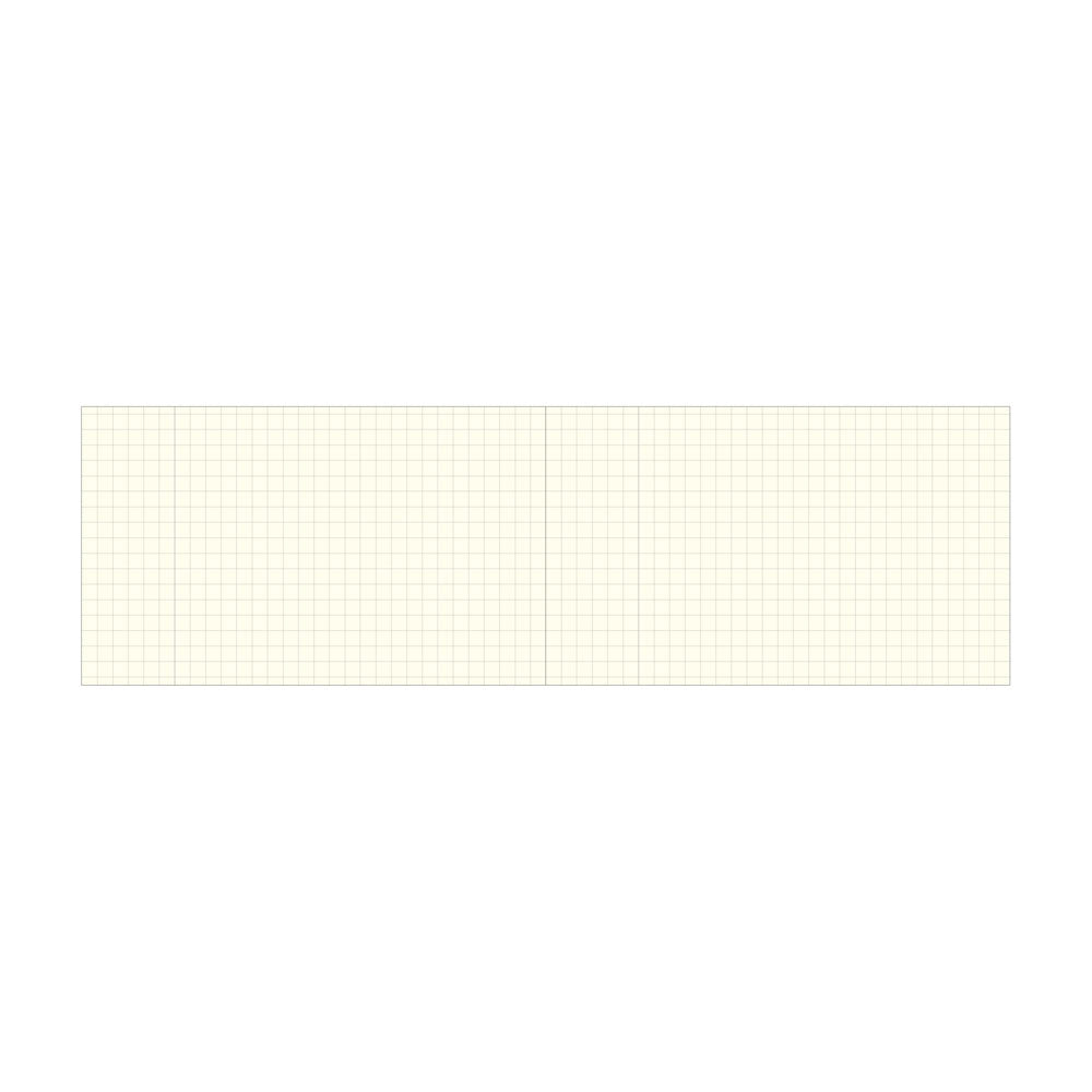 The Isshoni Laptop Notebook - Grid is a rectangular sheet of light yellow graph paper with a faint grid, shown horizontally and featuring a vertical fold line. Unmarked and made in Japan, its perfect for desktop notebooks or 13 laptops.