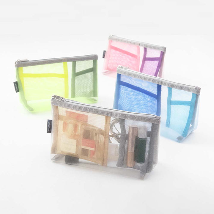 Four Midori Pen & Tool Mesh Pouch with Gusset cases in yellow, pink, blue, and gray are arranged on a white surface, each displaying assorted small items inside.