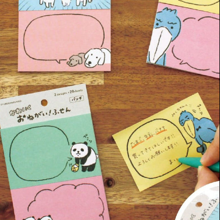Set of small post-it notes with cartoon designs on a wooden surface