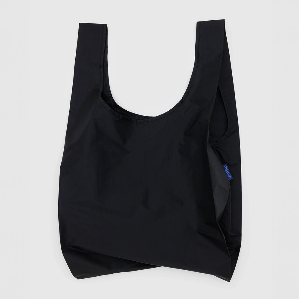 A flat, black reusable nylon bag with wide straps, designed to be carried over the shoulder.
