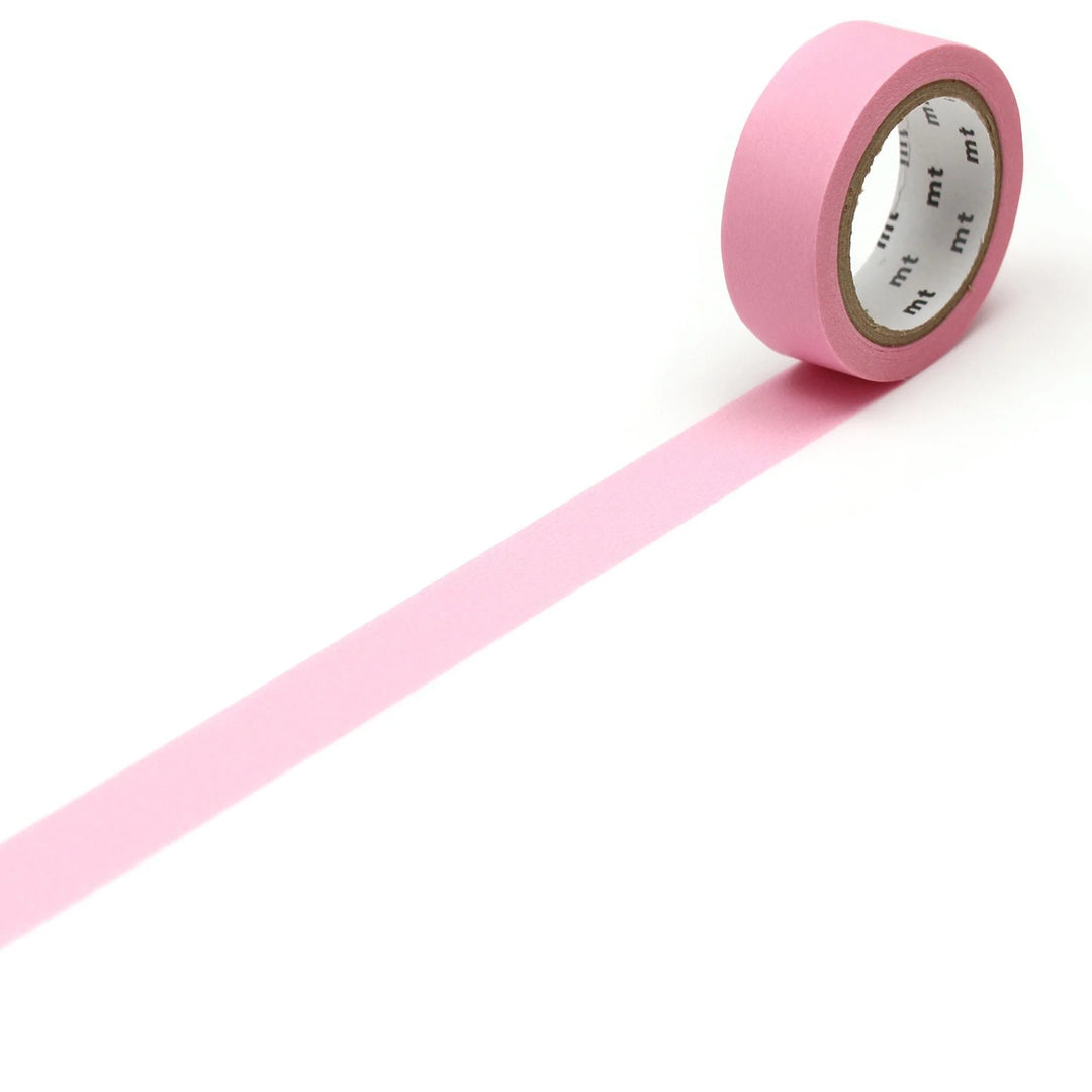 Pink washi tape with a white label on a white background