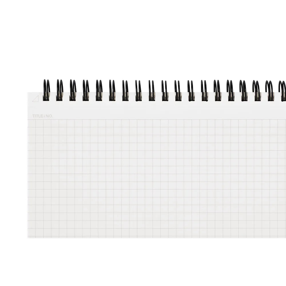 Small spiral-bound notebook with grid paper on a white background #paper-size_a4