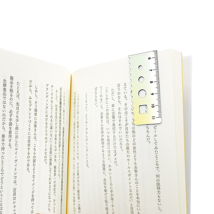 Kyoei gradient magnetic bookmark in green to yellow, folded over a book page as a page marker #colour_green-to-yellow