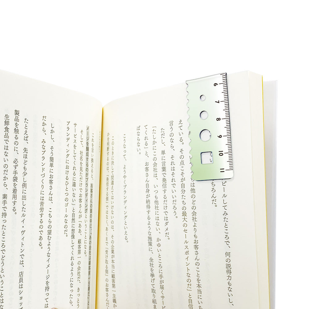 Kyoei gradient magnetic bookmark in blue to green, folded over a book page as a page marker #colour_blue-to-green