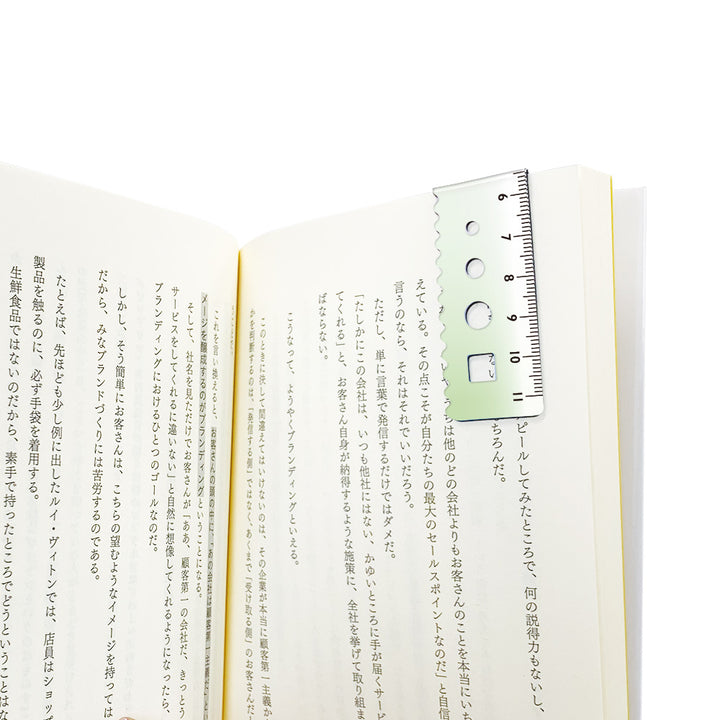 Kyoei gradient magnetic bookmark in blue to green, folded over a book page as a page marker #colour_blue-to-green