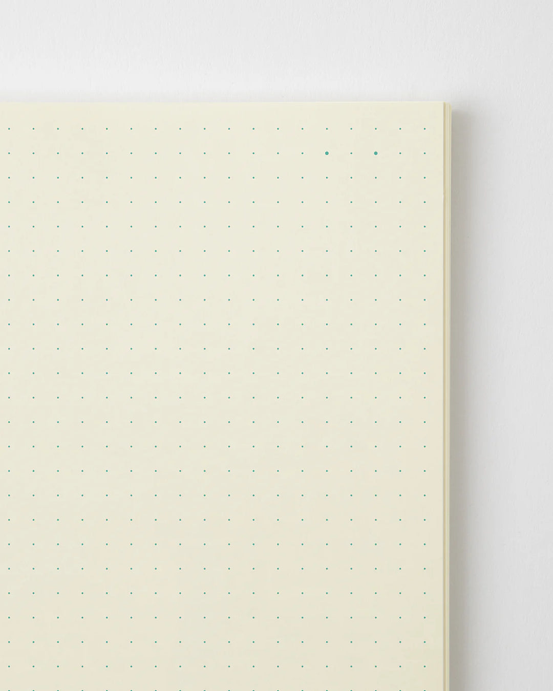 Notebook with grid pattern on beige cover against a white background