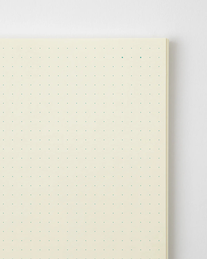 Notebook with grid pattern on beige cover against a white background